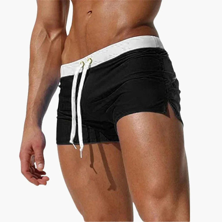 Durable men's quick-dry swim shorts, offering comfort and style with a prominent contrast waistband.
