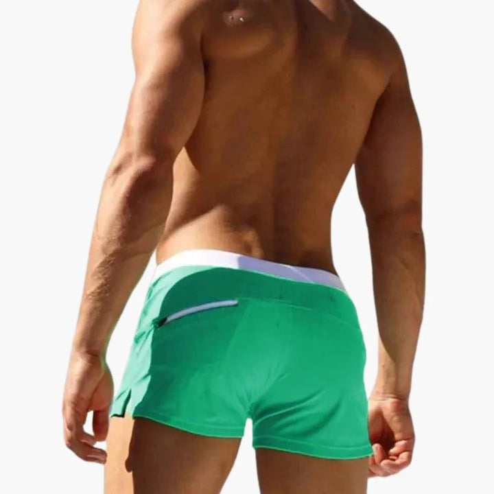Vibrant men's quick-dry pool shorts featuring a fashionable contrast waistband for active wear.