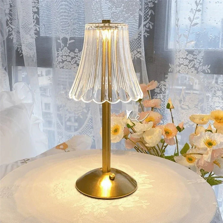 Versatile LED crystal lamp, touch activated, gold base, ideal for various room settings.