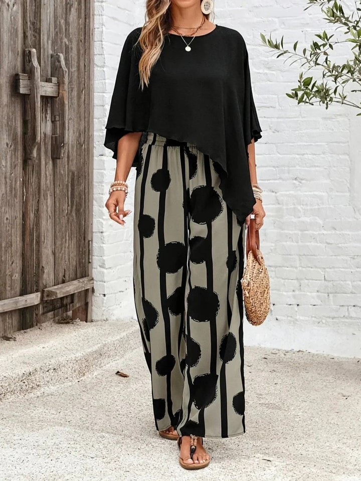 Elegant women's two-piece outfit: asymmetric top and flowing printed trousers. A stylish co-ord set for women.