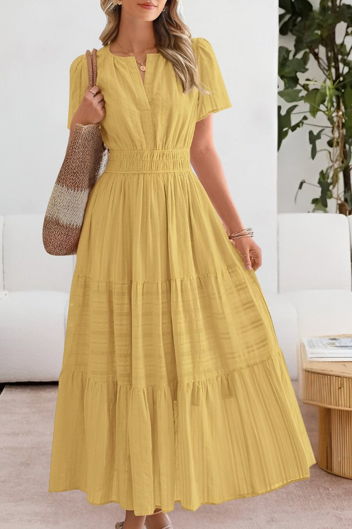 Women's graceful boho tiered maxi dress with flutter sleeves, perfect for summer casual chic.