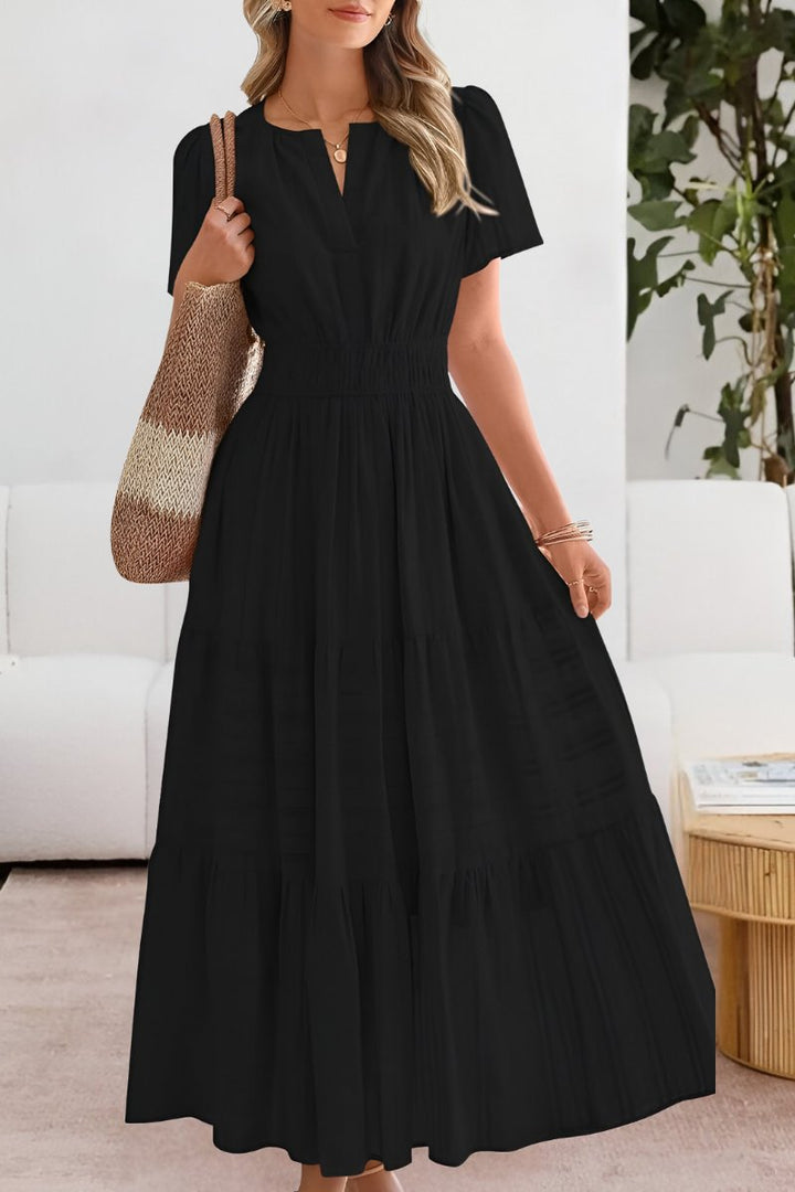 Flowy women's boho maxi dress featuring a tiered skirt and elegant flutter sleeves.