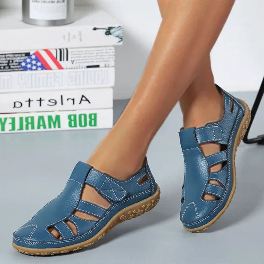 Supportive women's closed-toe orthopedic shoes with adjustable strap for customized arch support.