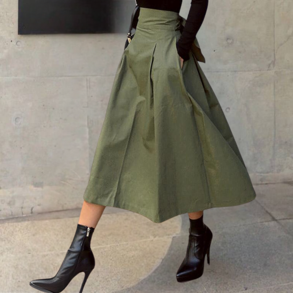 Fashionable women's midi skirt: high-waisted, pleated A-line design. A versatile, effortless addition to any wardrobe.