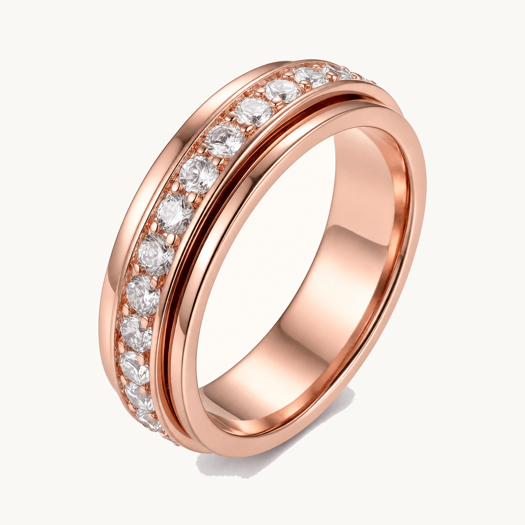 Stylish gold-tone sparkling zirconia spinner ring for women, a fashionable anxiety relief jewelry piece.