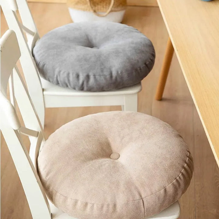 Round meditation cushion for yoga & floor support, promoting comfort & relaxation.