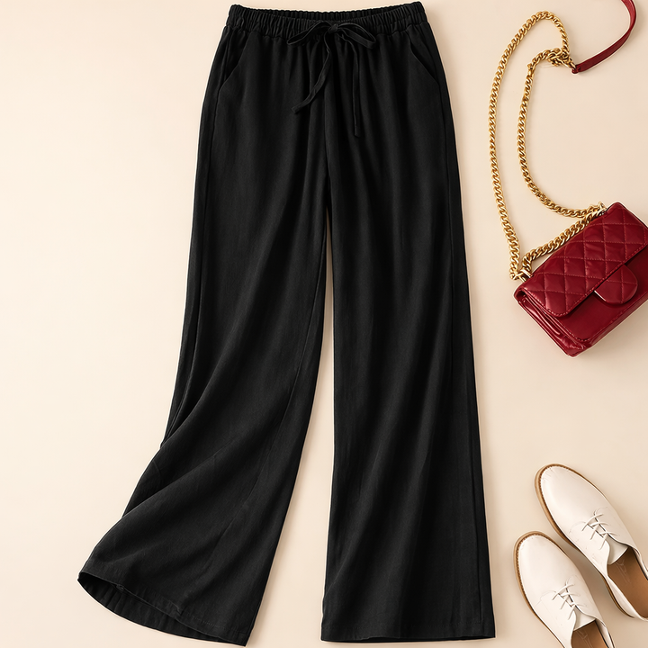 Close-up of women's wide leg drawstring pants waistband, highlighting comfort & relaxed fit. Stylish casual bottoms.