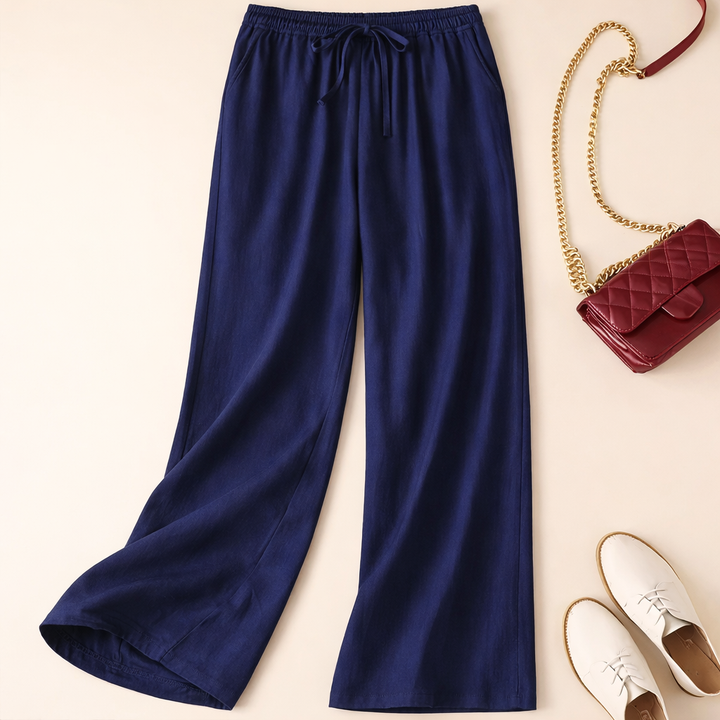 Back view of women's wide leg pants, featuring a comfortable drawstring waist & flowy relaxed fit. Great casual bottoms.