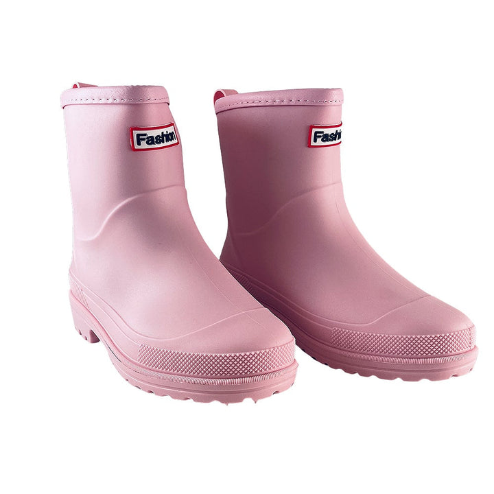 Stylish pink women's ankle rain boots, offering waterproof comfort and a fashionable look in wet weather.