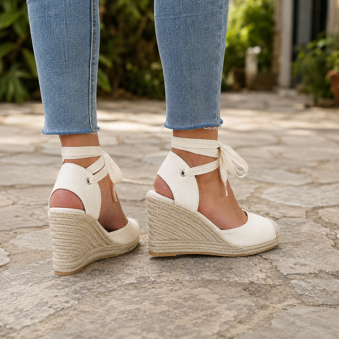 Elegant women's closed-toe espadrille wedges with lace-up straps, versatile for summer outings & beach style.