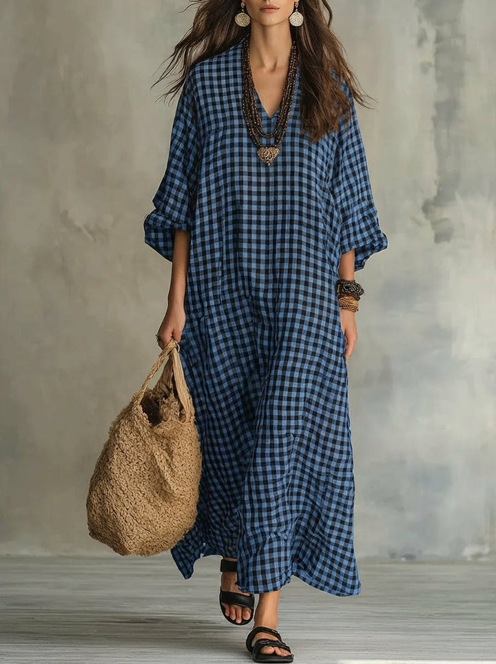 Full-length view of a women's oversized gingham maxi dress, flowy V-neck, long-sleeve, ideal for casual summer fashion.