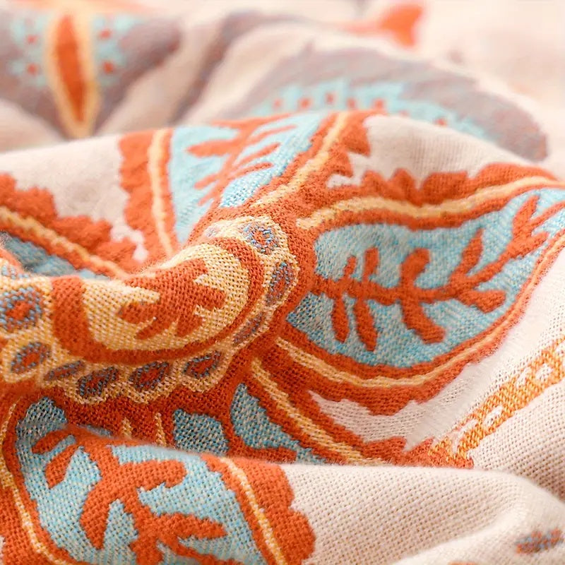 Vibrant floral cotton throw blanket, a soft boho home accent. Ideal for cozy living room decor & gifting.