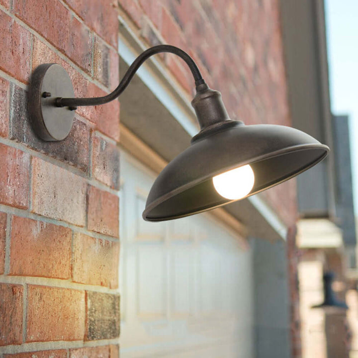 Vintage brass outdoor wall lamp for patio, garden, or rustic exterior decor.