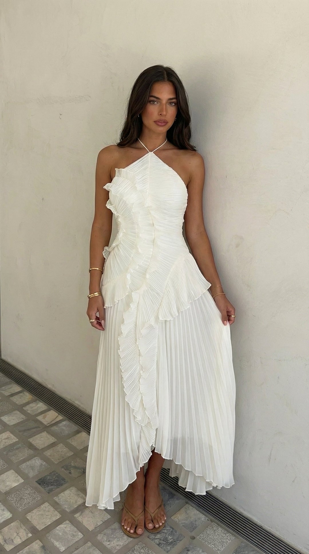 Special occasion maxi dress with unique halter neck and ruffled hem.