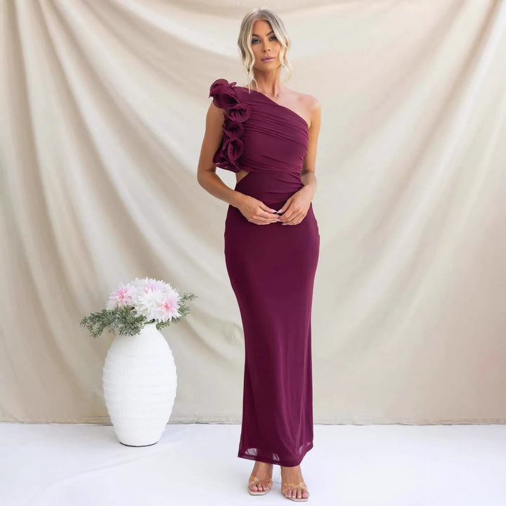 Stylish woman posing in a chic one-shoulder ruffle maxi dress for evening wear & special occasions.