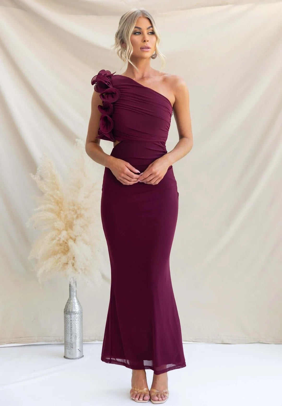 Modern women's evening wear: elegant one-shoulder ruffle maxi dress, sophisticated formal style.