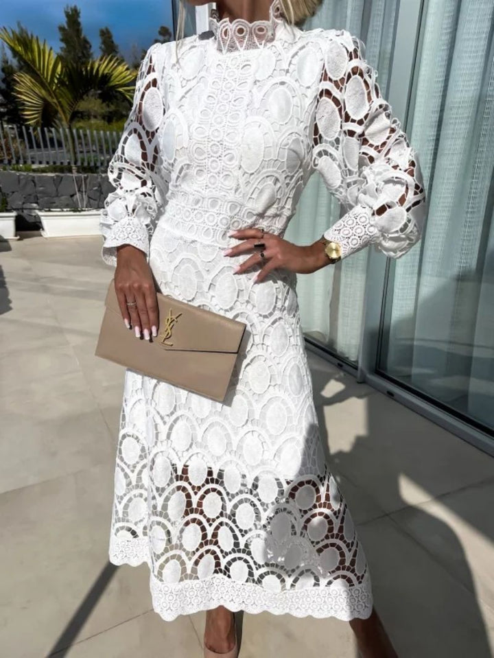 Fitted waist midi cocktail dress for women, featuring a high neck, long sleeves & scalloped hem. Ideal for parties.