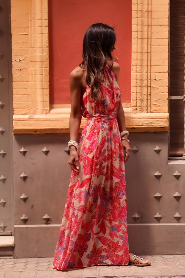 Women's elegant floral halter neck maxi beach dress for summer resort wear.