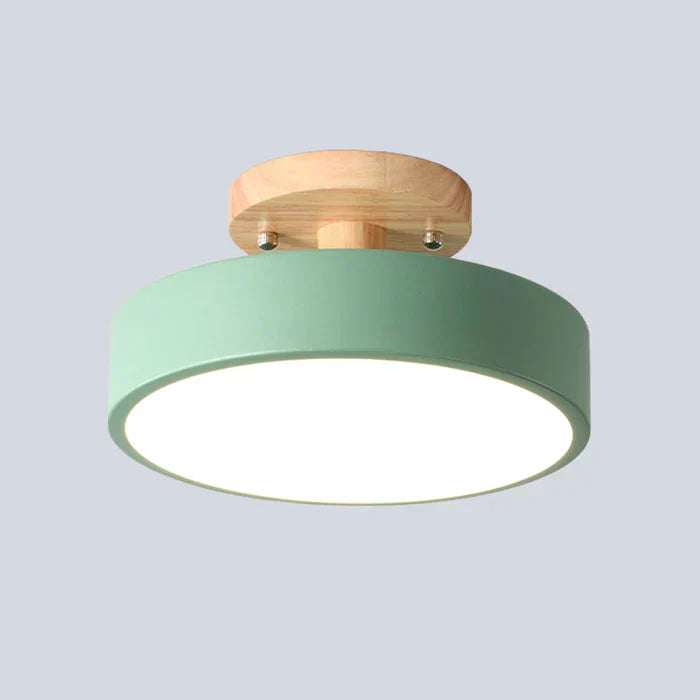Modern flush mount ceiling fixture with Scandinavian wood details.