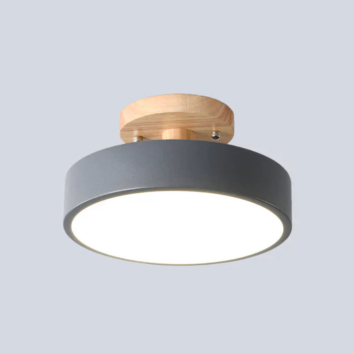 Sleek wood and metal flush mount light for entryway decor.