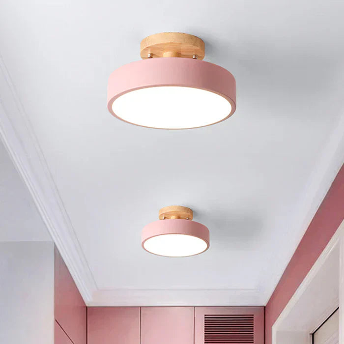 Contemporary wood-accented LED flush mount light fixture.