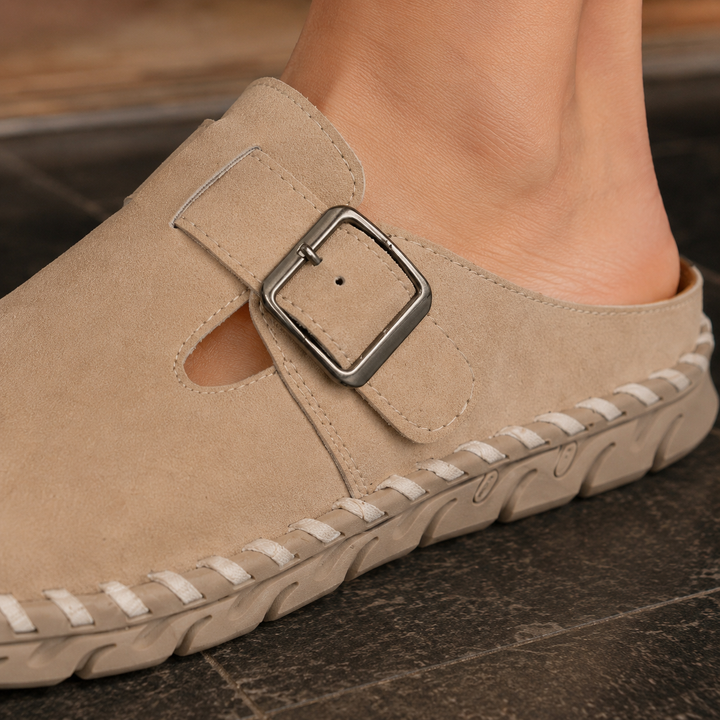 Comfortable men's mules, black, featuring a stylish buckle strap and durable stitched sole for everyday wear.