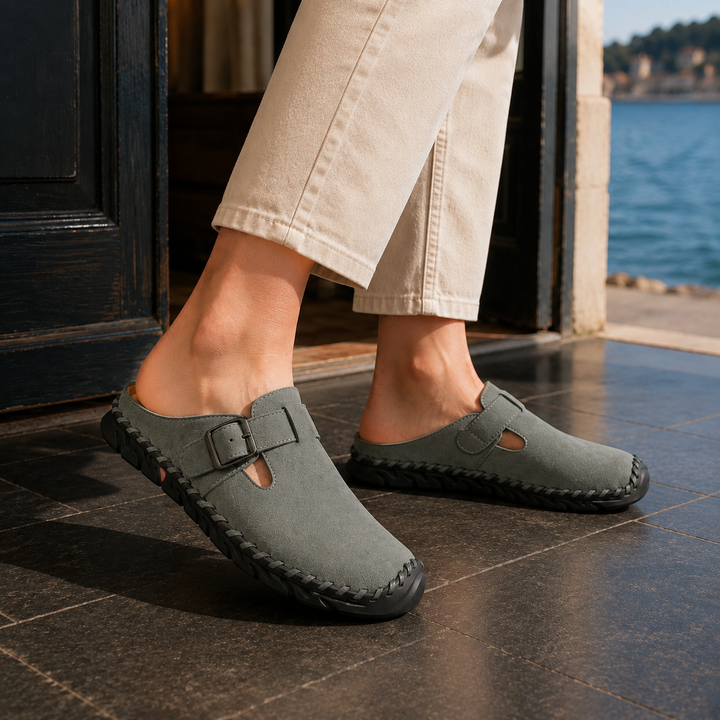 Men's casual clogs with a sturdy stitched sole and stylish buckle strap, offering comfortable slip-on wear.