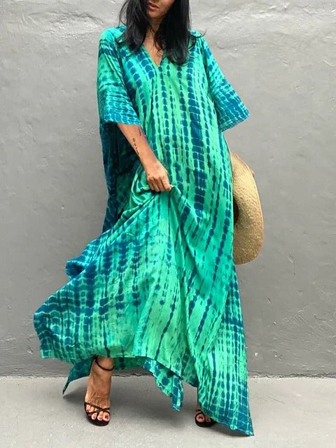 Women's elegant tie-dye kaftan maxi beach dress. Flowing V-neck resort wear for summer vacation.