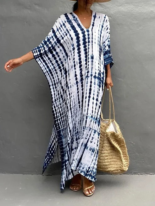 Casual women's tie-dye maxi dress. Flowing kaftan style, V-neck, great for beach or resort wear.