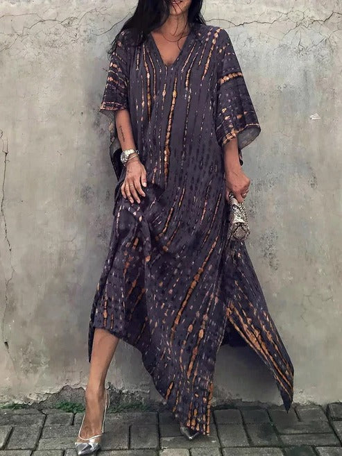 Women's elegant tie-dye summer dress. Flowing V-neck kaftan maxi for beach and resort vacation.