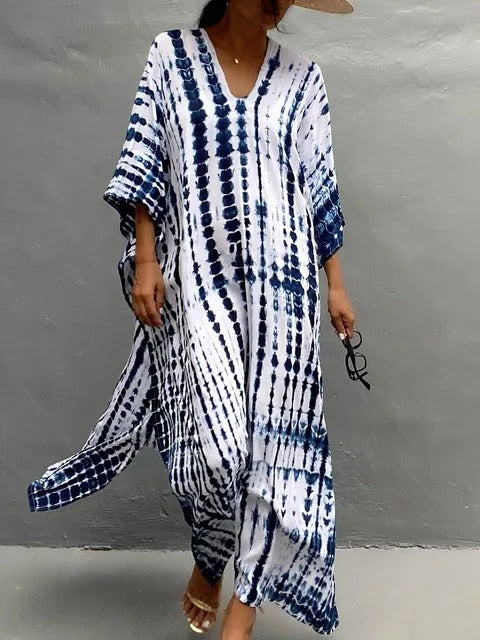 Flowing women's tie-dye maxi dress, boho chic style. Comfortable kaftan for beach, resort, or summer.