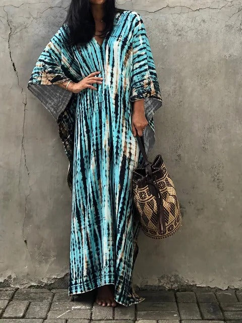 Elegant women's tie-dye kaftan maxi dress with V-neck. Stylish resort wear for summer vacations.