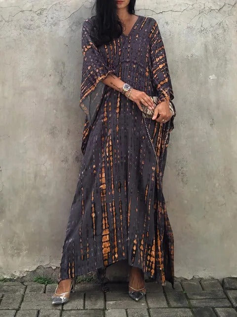 Boho chic tie-dye V-neck kaftan maxi dress. Women's elegant summer vacation and beach attire.