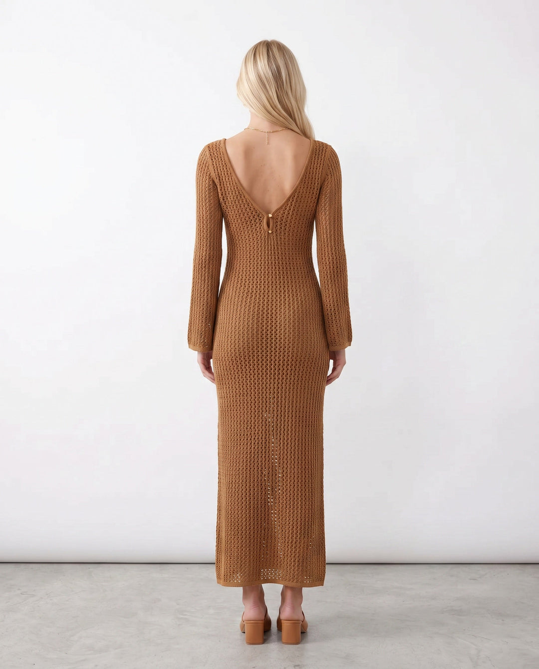 Stylish women's plunge neck crochet maxi dress. Elegant long sleeve design for summer.