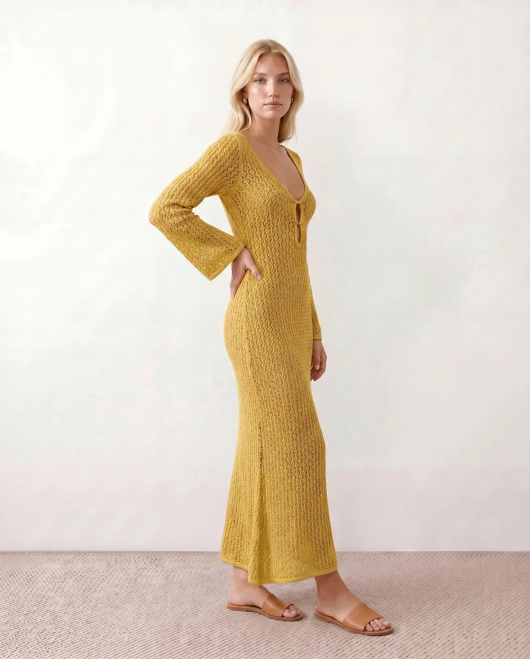 Fashionable women's crochet maxi dress with deep V-neck. Long sleeve boho style.