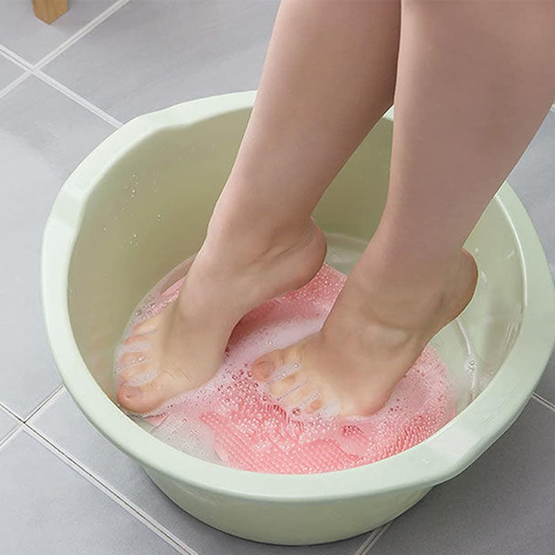 Durable silicone foot cleaner and body scrubber with suction cups for secure shower use.