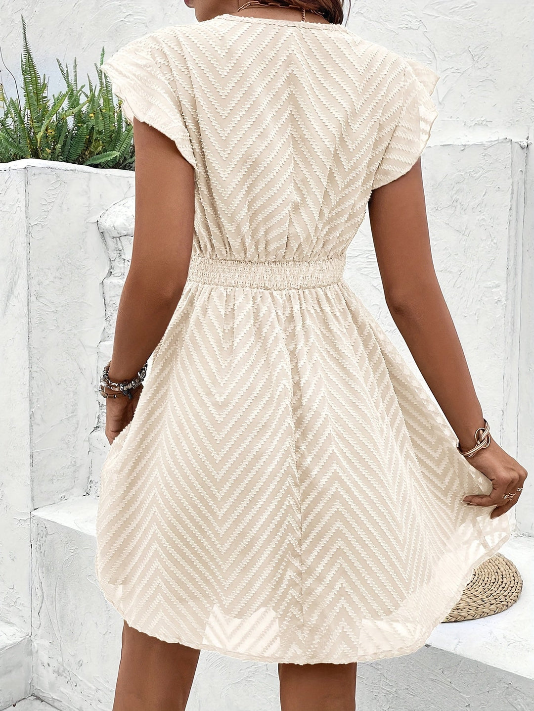 White women's chic V-neck mini dress. Short sleeve summer vacation dress, great for elegant casual style.