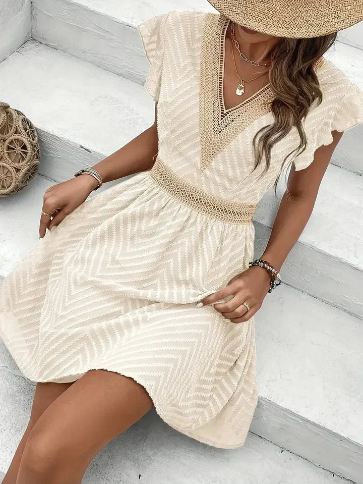 Elegant V-neck mini dress, perfect for women's summer fashion. Chic short sleeve style for parties & vacation.