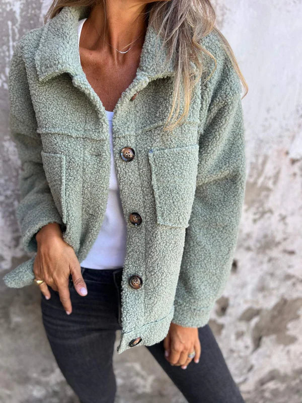 Chic women's cozy teddy coat, a warm short jacket with a sophisticated lapel collar for cool weather.