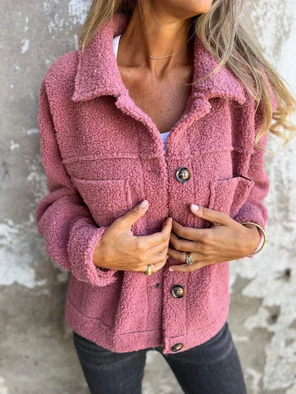 Woman wearing a cozy teddy short jacket with a stylish lapel collar. Perfect comfortable outerwear for autumn.