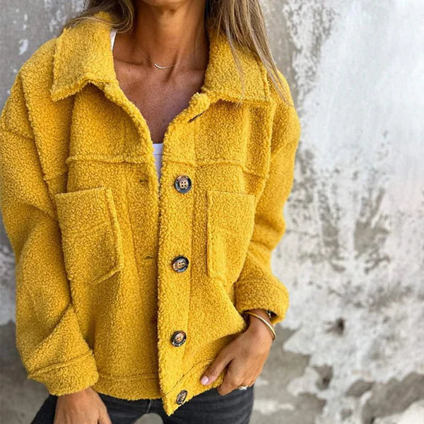 Women's cozy teddy coat with stylish lapel collar. Short, warm autumn/winter jacket for casual wear.