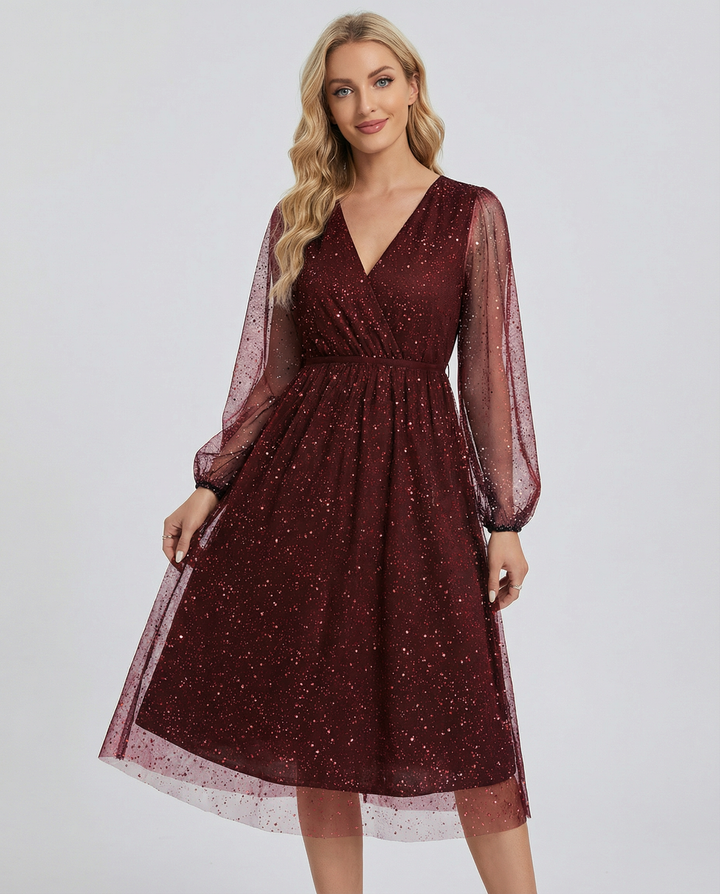 Elegant women's sparkly mini dress with shimmering mesh sleeves. Ideal for parties, evening wear & glamorous events.