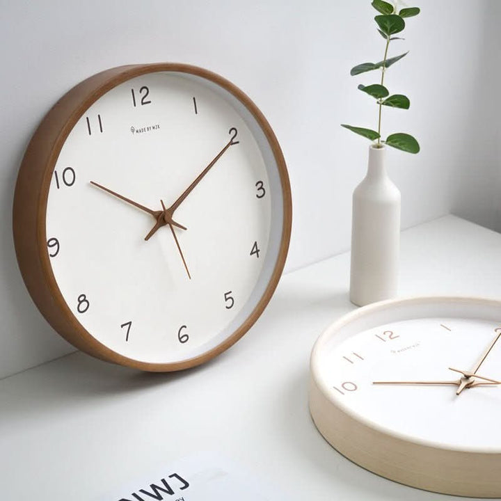 Elegant minimalist analog wall clock, handcrafted from solid wood, a silent addition to any room.