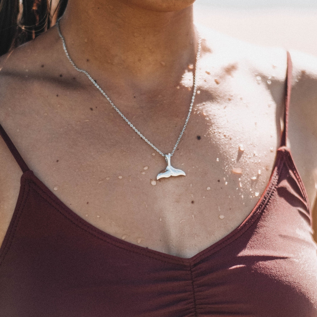 Women's marine jewelry, an elegant whale tail necklace in silver.