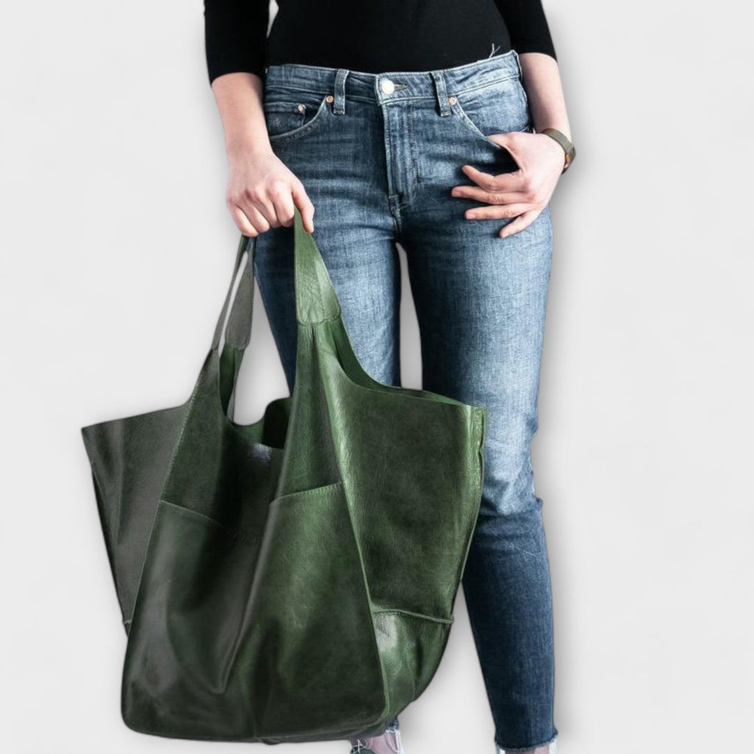 Women's spacious black leather duffel bag, oversized travel tote for weekend adventures.