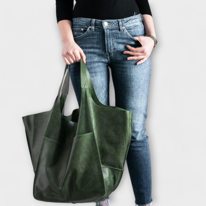 Women's spacious black leather duffel bag, oversized travel tote for weekend adventures.