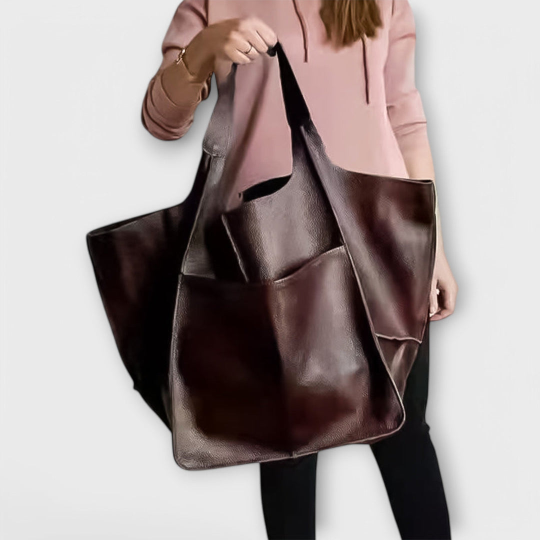 Full view of stylish oversized leather weekender bag for women, ready for travel.