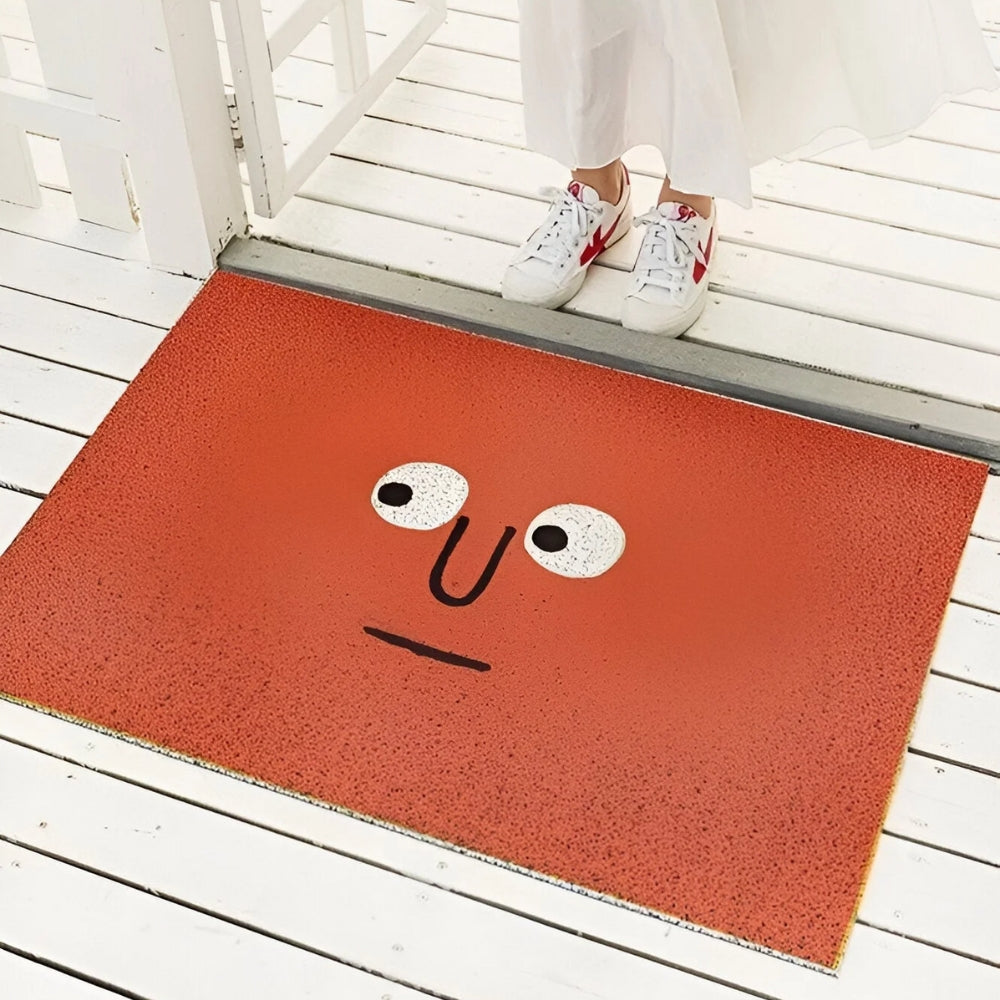 Smiling face rug, a cheerful welcome mat for your home. Non-slip design, ideal for indoor/outdoor use.