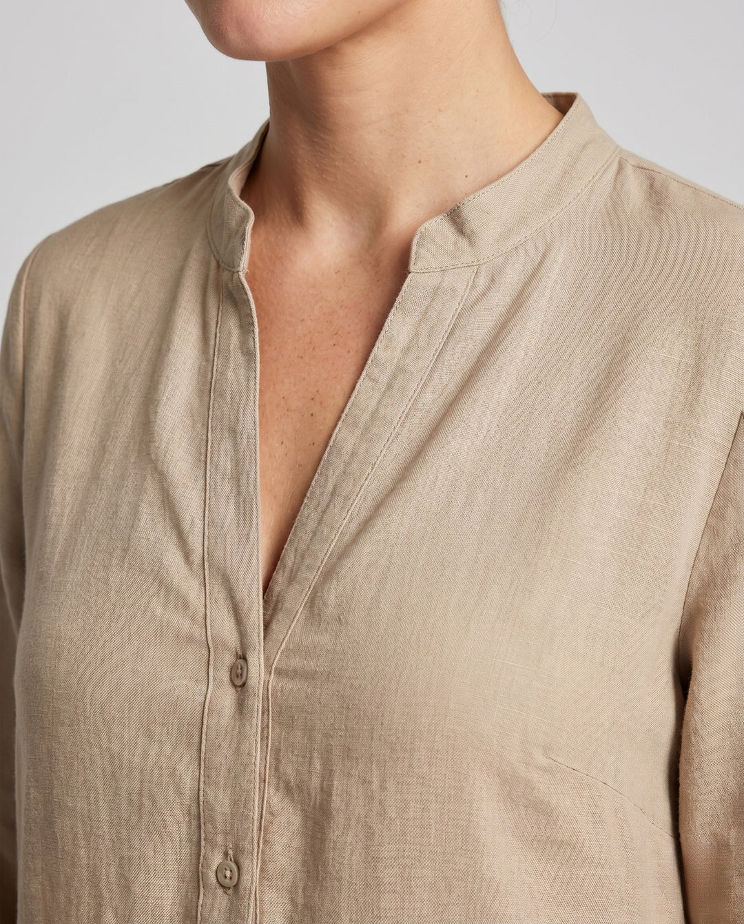 Elegant women's tiered midi dress featuring a stylish button placket and three-quarter sleeves.