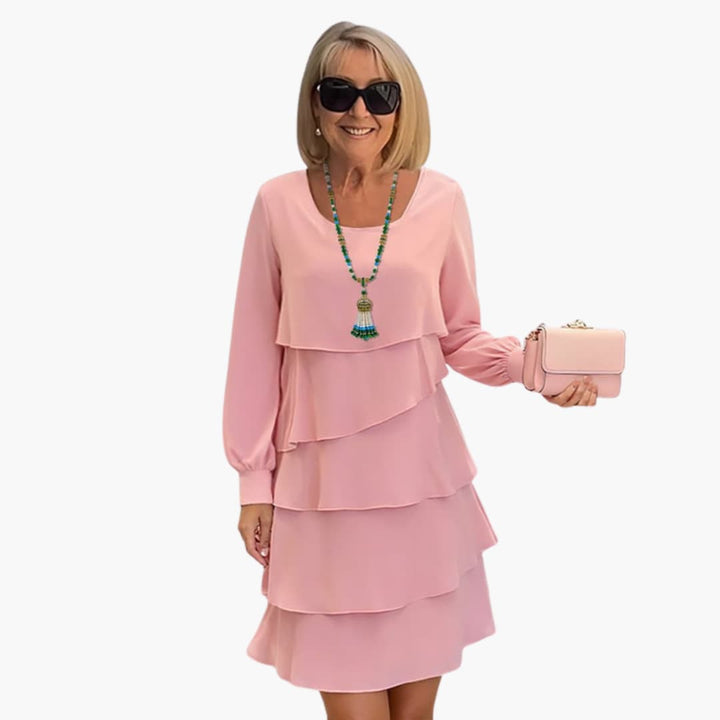 Detailed view of women's tiered ruffle party dress. Features elegant long sleeves, a scoop neck, & a comfortable flowy design.